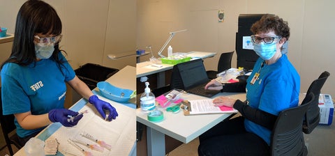 Robin Andrade and Rosemary Killeen wearing PPE and preparing syringes