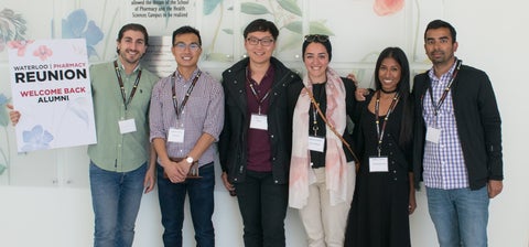 Six Rx2016 students smiling holding a banner that says Reunion Welcome Back Alumni