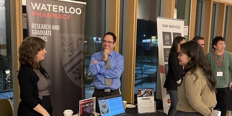 3 people talking at a career fair table