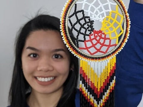 Celine smiling with dreamcatcher