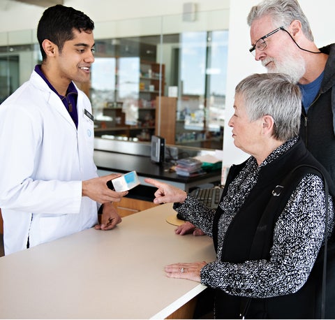 Pharmacist consulting patients