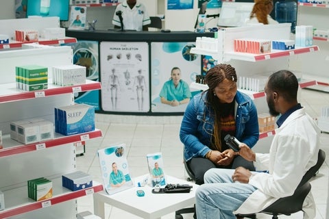 Pharmacist speaking with a patient in the hospital
