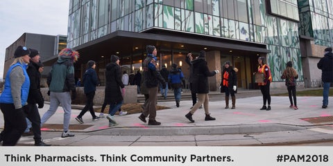 Think Pharmacists. Think Community Partners. #Pam2018. People walking outside the School of Pharmacy.