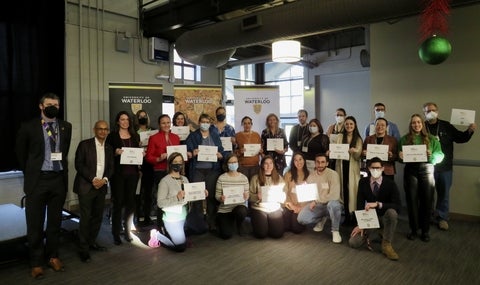 Students at faculty at the Sustainability Office awards ceremony with their certificates.