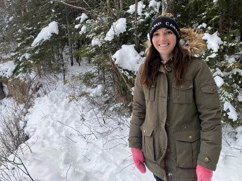 Blair McCullough smiling in winter forest