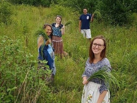 People standing in a sweetgrass field