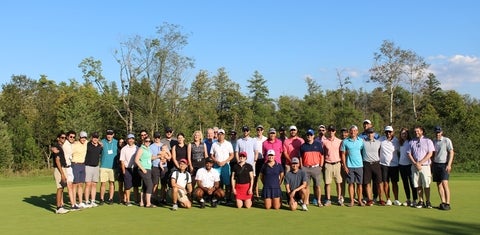 A group photo of golfers on grass