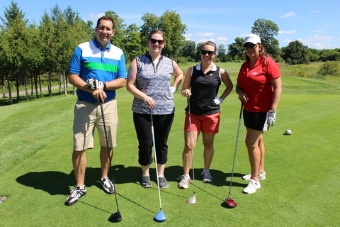 Four golfers on the green