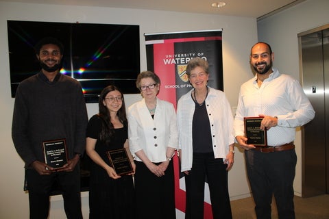 Group of people smiling holding awards