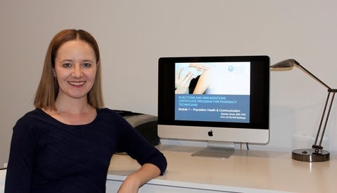 Sherilyn Houle in front a computer with the injections training course on screen
