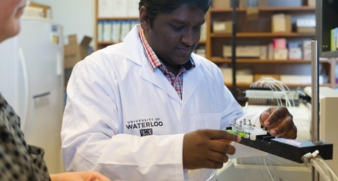 Lokesh in the lab preparing research equipment.