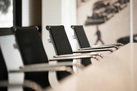 Chairs lined up in an empty conference room