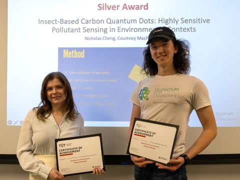 Courtney MacPherson and Nicholas Cheng holding award certificates