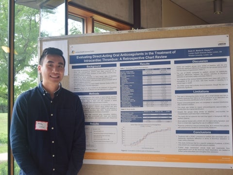 Andy Kwok beside his scientific poster