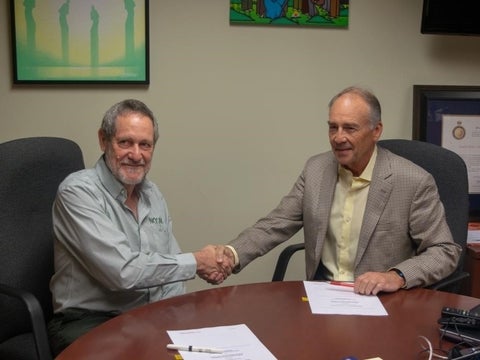 Dr. Roger Strasser, Founding Dean of NOSM, signing a memorandum of understanding with Hallman Director David Edwards.