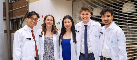five pharmacy students with white coats