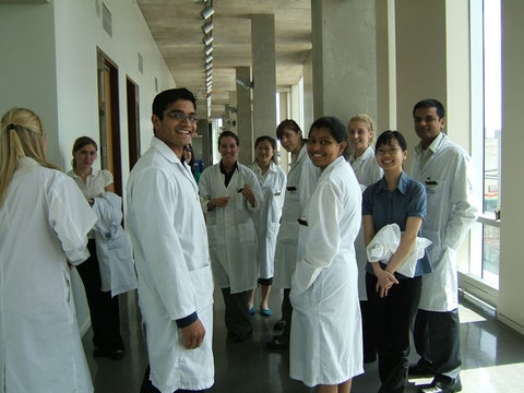 A group of students standing in white coats