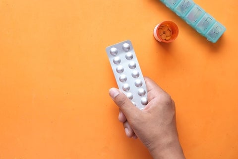 hand holding pill container