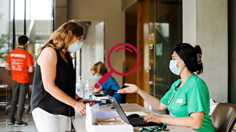 Female pharmacist staff talking to another female.