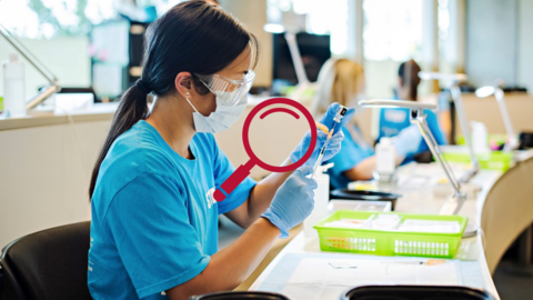 Women wearing medical mask and gloves holding syringe 