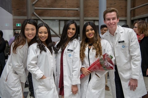 five PharmD students at the White Coat Ceremony