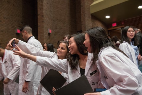 students at the White Coat Ceremony taking a selfie
