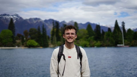 Marcus Yurcuk smiling in front of mountains in New Zealand