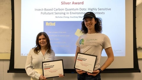 Courtney MacPherson and Nicholas Cheng holding award certificates