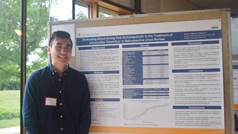 Andy Kwok beside his scientific poster