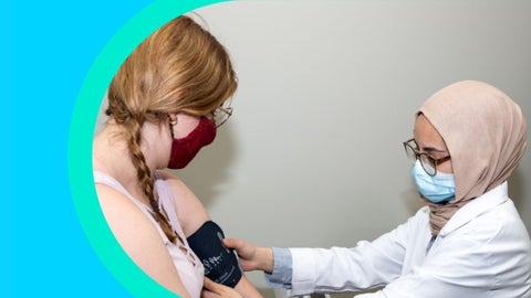 A pharmacist consulting a patient