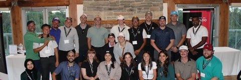 A group of people in a banquet room smiling
