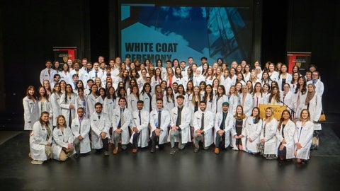 A group of students in white coats