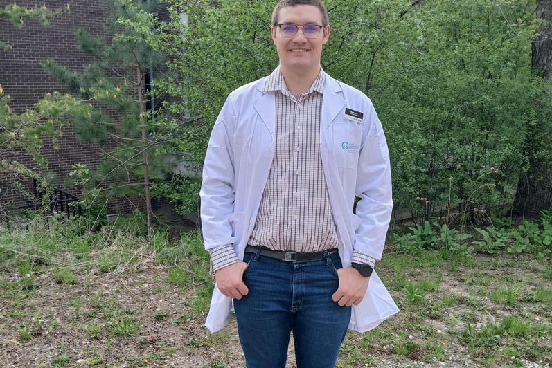 Graham Peeters smiling in a white coat outside