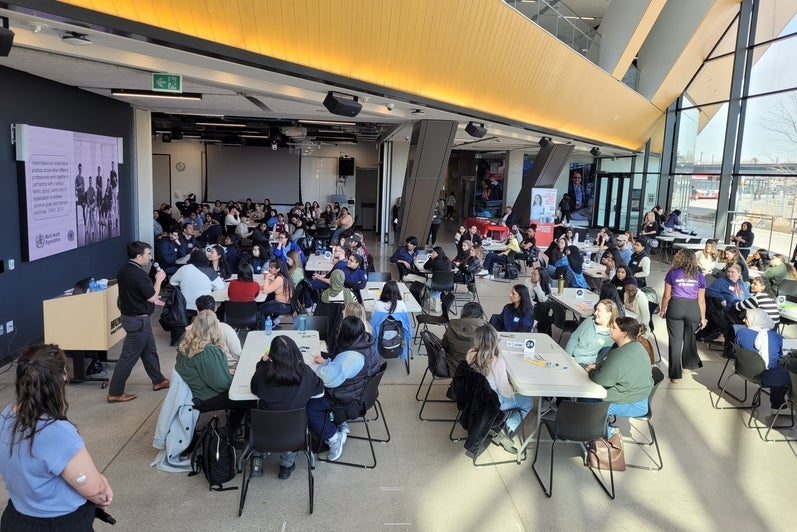 Students sitting at tables in discussion
