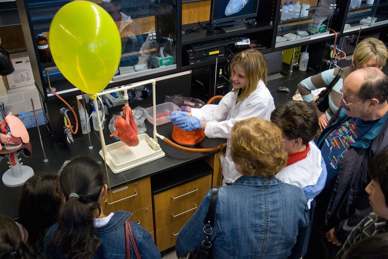 woman demonstrating to public in lab