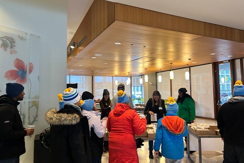 People standing in a line to grab snacks and a beverage in a lobby