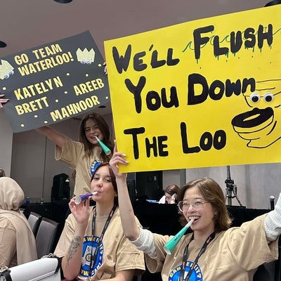 Students cheering holding signs