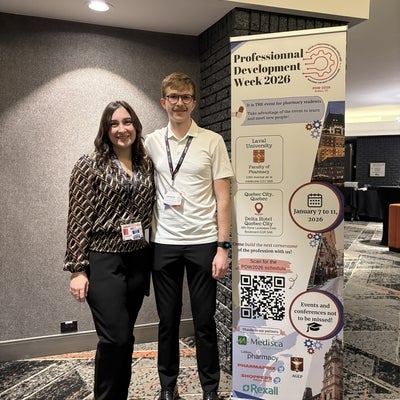 Students standing next to a banner