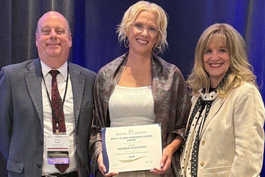 Dr. Edginton holding up the 2026 AFPC Research Career Award