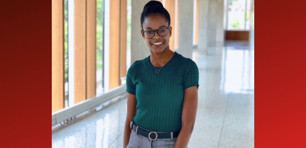 Brittani Brown smiling standing in a hallway 