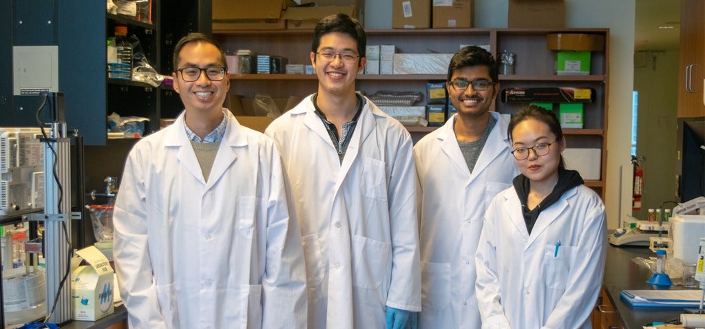 Emmanuel Ho and his students in the lab
