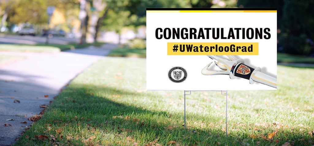 Convocation Uwaterloo Grad sign on a lawn