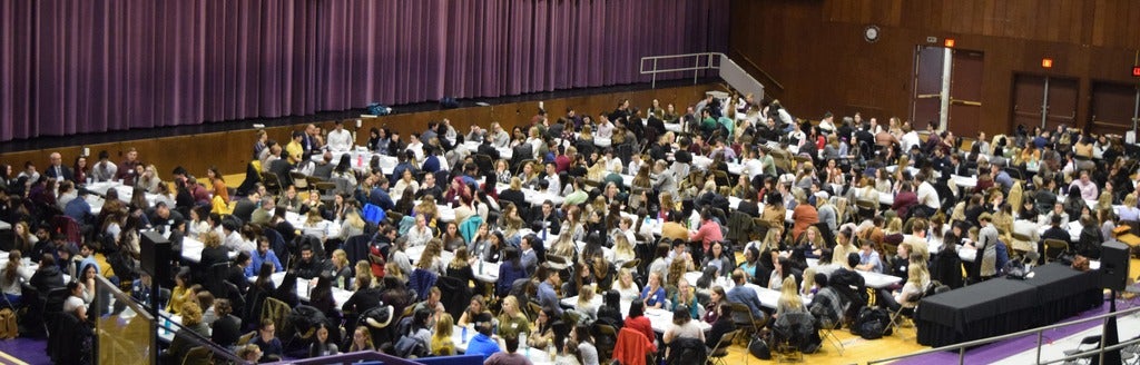 Students gathering in groups for discussions at IPE Day