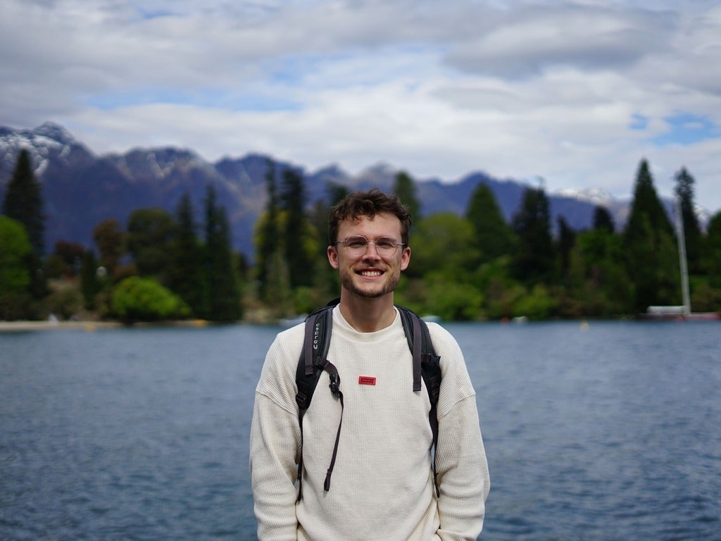 Marcus Yurchuk smiling in front of mountains in New Zealand