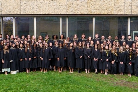 A large group of graduates smiling in their robes