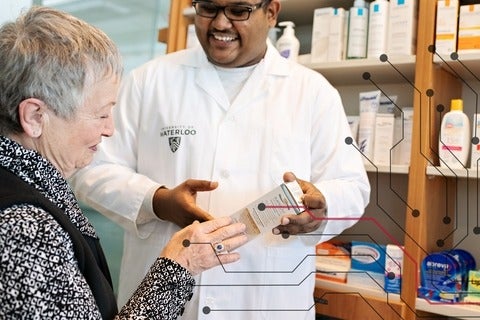 A pharmacist consulting a patient about a medication