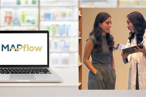 A laptop with MAPflow software displayed next to a pharmacist and patient in discussion