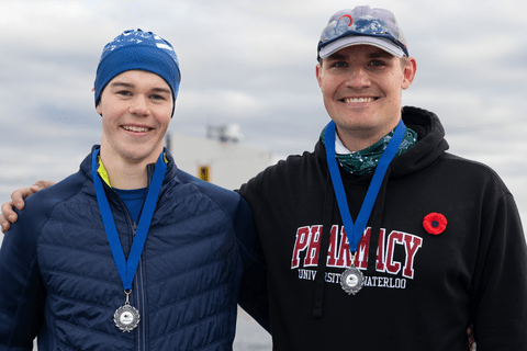 Callum Myers and Graham Peeters smiling wearing medals