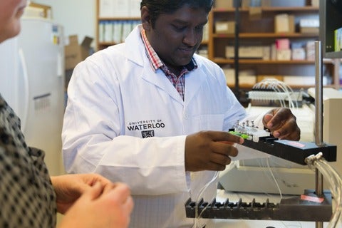 Lokesh in the lab preparing a piece of research equipment