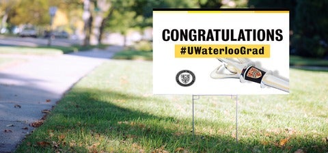 Convocation Uwaterloo Grad sign on a lawn